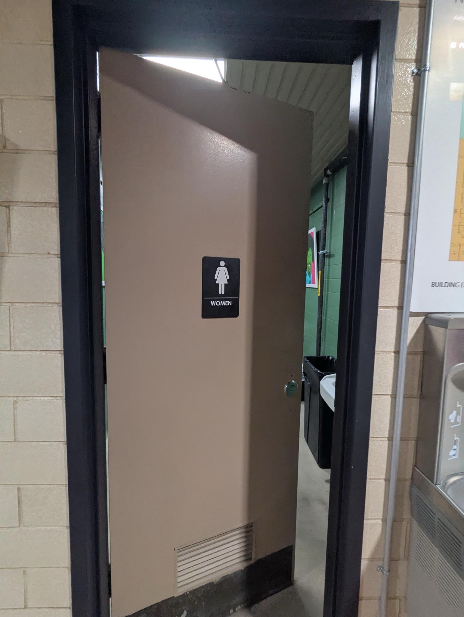 A photo of the outside of a single-stall bathroom