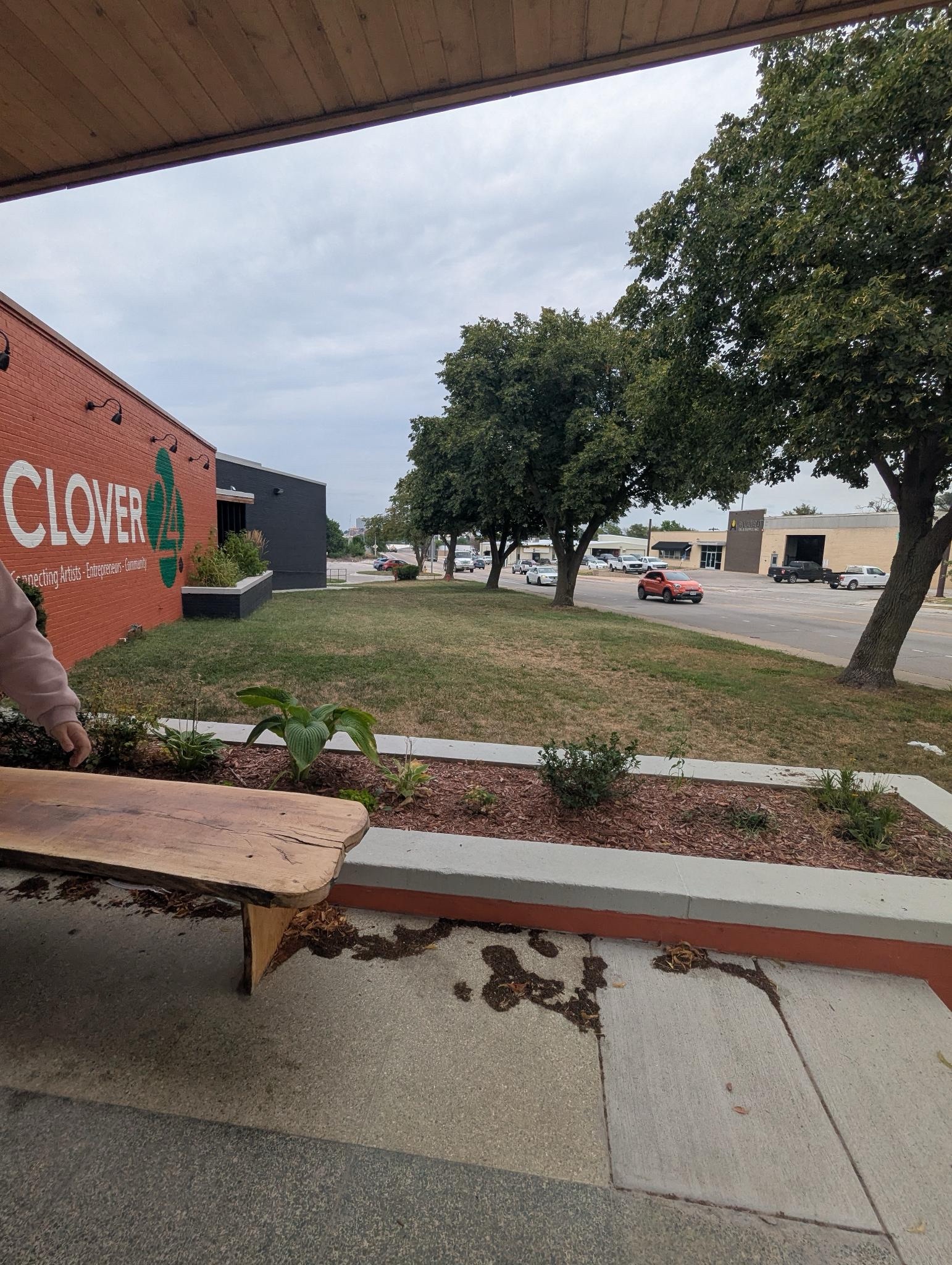 A photo showing a bench, taken in front of the Clover 24 entrance